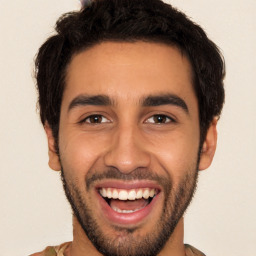 Joyful white young-adult male with short  black hair and brown eyes