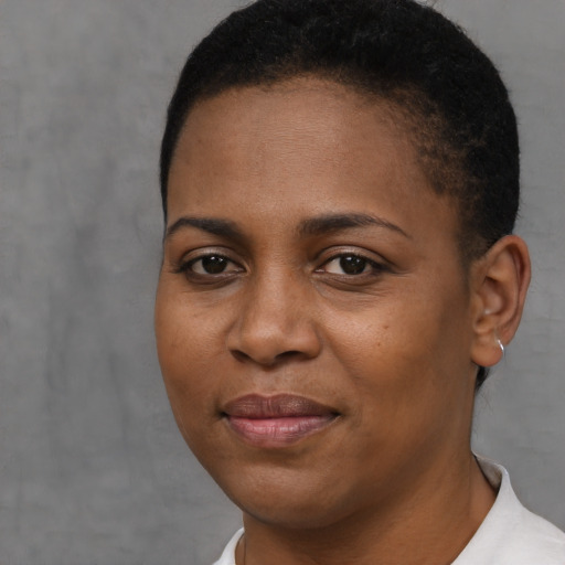 Joyful black young-adult female with short  brown hair and brown eyes