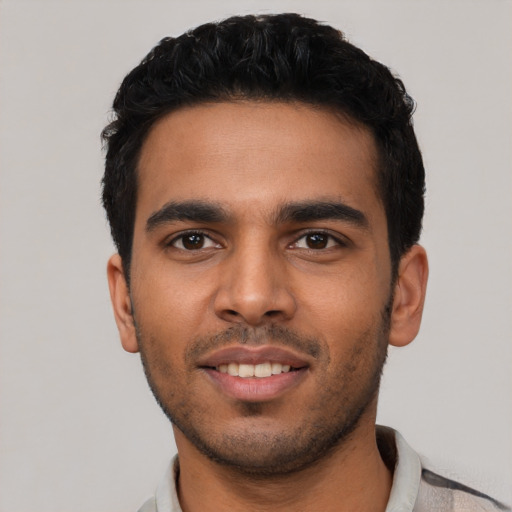 Joyful latino young-adult male with short  black hair and brown eyes