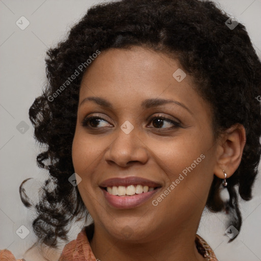 Joyful black young-adult female with medium  brown hair and brown eyes