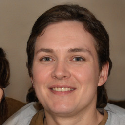 Joyful white adult female with medium  brown hair and brown eyes