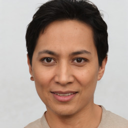 Joyful asian young-adult female with short  black hair and brown eyes