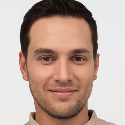 Joyful white young-adult male with short  brown hair and brown eyes