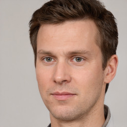 Joyful white adult male with short  brown hair and brown eyes