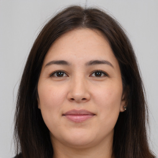 Joyful white young-adult female with long  brown hair and brown eyes