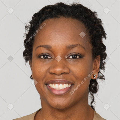 Joyful black young-adult female with long  brown hair and brown eyes