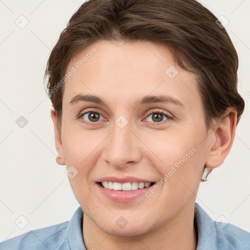 Joyful white young-adult female with short  brown hair and grey eyes