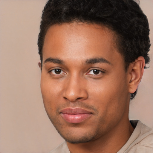 Joyful black young-adult male with short  brown hair and brown eyes