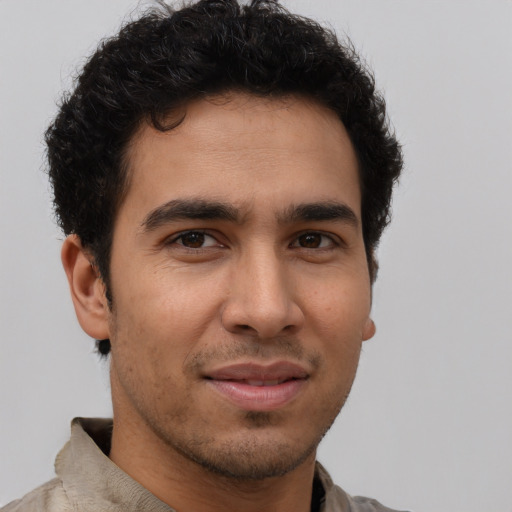 Joyful latino young-adult male with short  brown hair and brown eyes