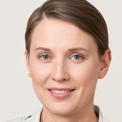 Joyful white young-adult female with short  brown hair and grey eyes