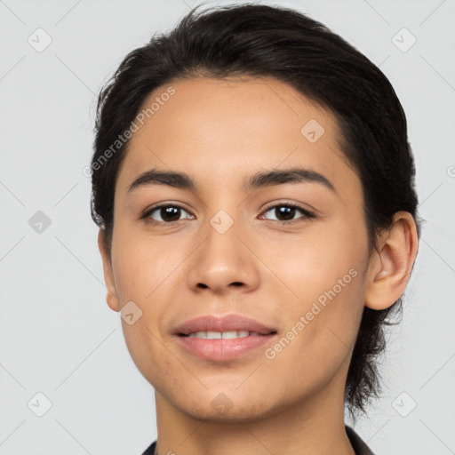 Joyful latino young-adult female with short  black hair and brown eyes