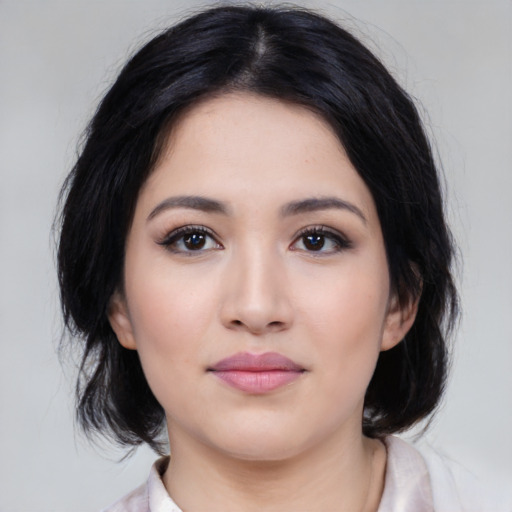 Joyful asian young-adult female with medium  black hair and brown eyes