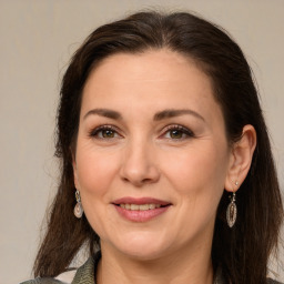 Joyful white adult female with long  brown hair and brown eyes