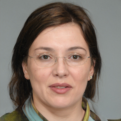 Joyful white adult female with medium  brown hair and brown eyes