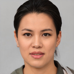 Joyful asian young-adult female with medium  brown hair and brown eyes