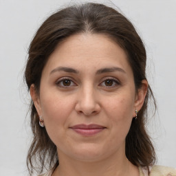 Joyful white adult female with medium  brown hair and brown eyes