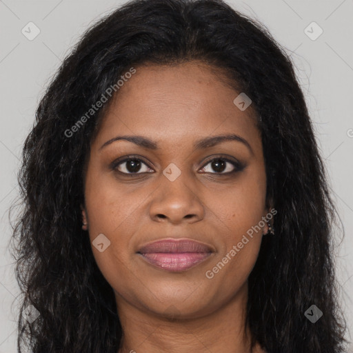 Joyful black young-adult female with long  brown hair and brown eyes