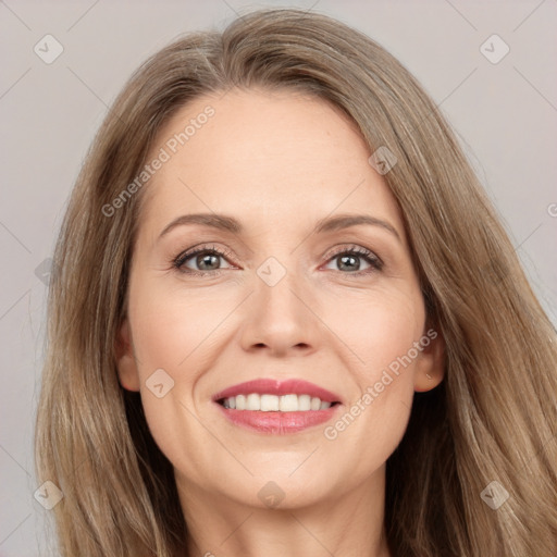 Joyful white adult female with long  brown hair and brown eyes