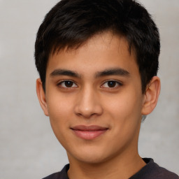 Joyful latino young-adult male with short  brown hair and brown eyes