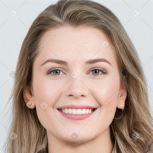 Joyful white young-adult female with long  brown hair and blue eyes