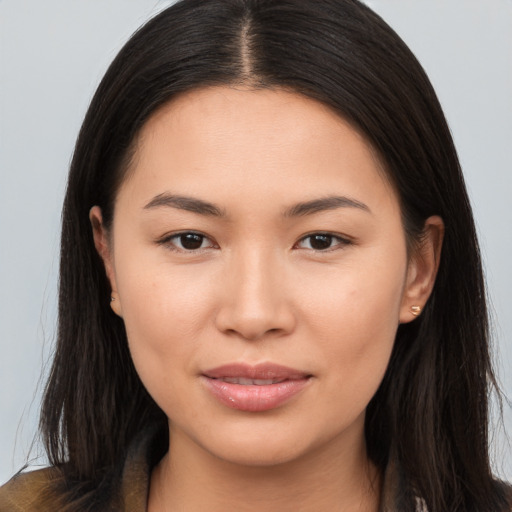 Joyful asian young-adult female with long  brown hair and brown eyes