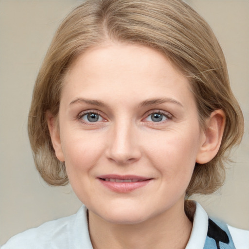 Joyful white young-adult female with medium  brown hair and blue eyes