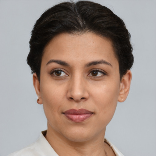 Joyful latino young-adult female with short  brown hair and brown eyes