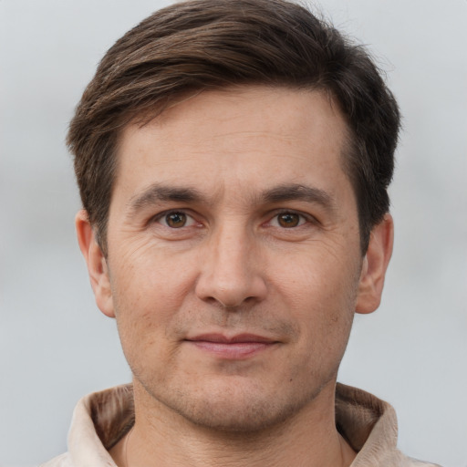 Joyful white adult male with short  brown hair and brown eyes