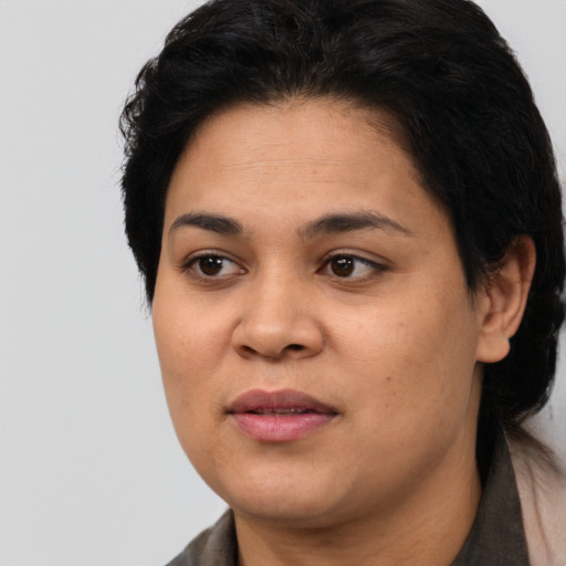 Joyful latino young-adult female with short  black hair and brown eyes