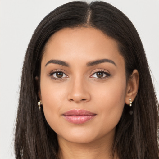 Joyful latino young-adult female with long  brown hair and brown eyes