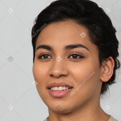 Joyful latino young-adult female with short  black hair and brown eyes