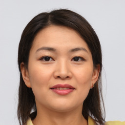 Joyful asian young-adult female with medium  brown hair and brown eyes