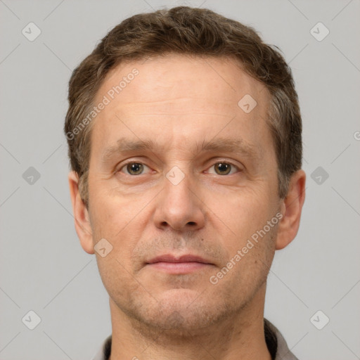 Joyful white adult male with short  brown hair and grey eyes