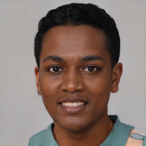 Joyful black young-adult male with short  black hair and brown eyes