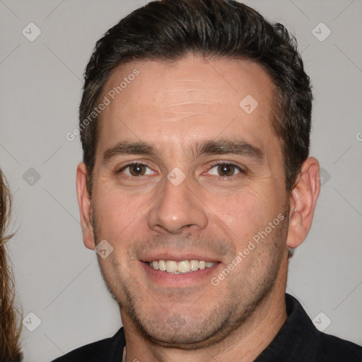 Joyful white adult male with short  brown hair and brown eyes