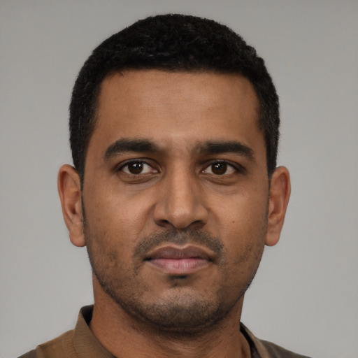 Neutral latino young-adult male with short  black hair and brown eyes