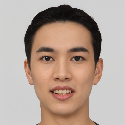 Joyful asian young-adult male with short  black hair and brown eyes