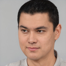 Joyful white young-adult male with short  black hair and brown eyes