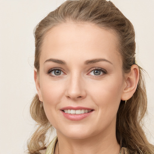 Joyful white young-adult female with long  brown hair and grey eyes