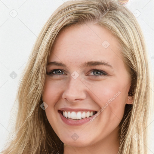 Joyful white young-adult female with long  brown hair and blue eyes