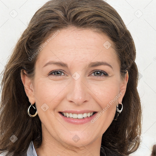 Joyful white adult female with long  brown hair and brown eyes