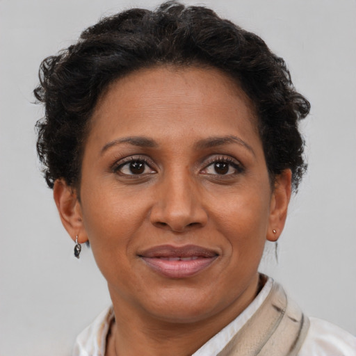 Joyful latino adult female with short  brown hair and brown eyes