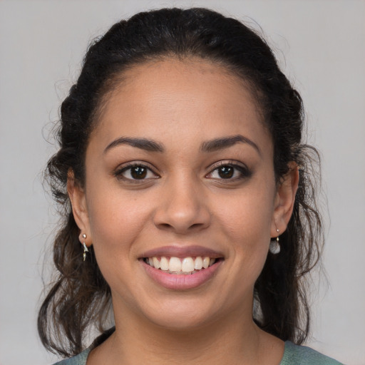 Joyful latino young-adult female with medium  brown hair and brown eyes