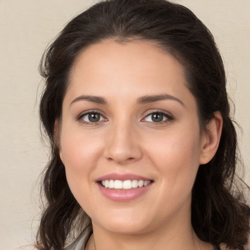 Joyful white young-adult female with medium  brown hair and brown eyes