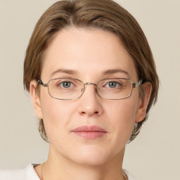 Joyful white adult female with medium  brown hair and grey eyes