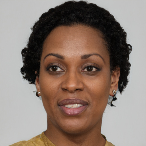 Joyful black adult female with short  black hair and brown eyes