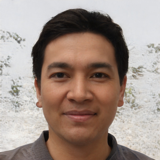 Joyful asian young-adult male with short  brown hair and brown eyes