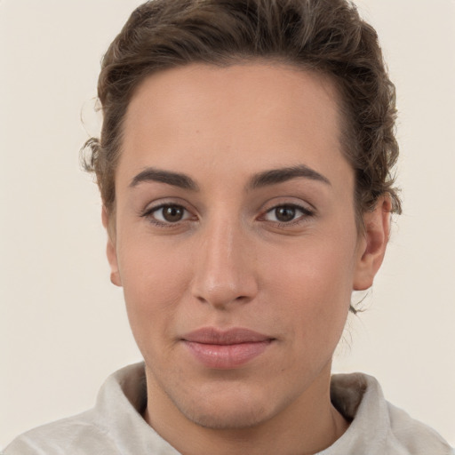 Joyful white young-adult female with short  brown hair and grey eyes