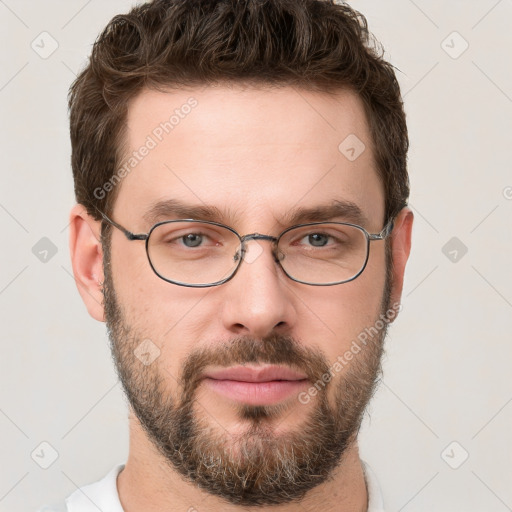 Joyful white young-adult male with short  brown hair and grey eyes