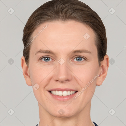 Joyful white young-adult female with short  brown hair and grey eyes